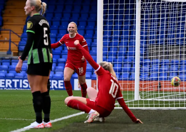 Ceri Holland of Liverpool celebrates scoring