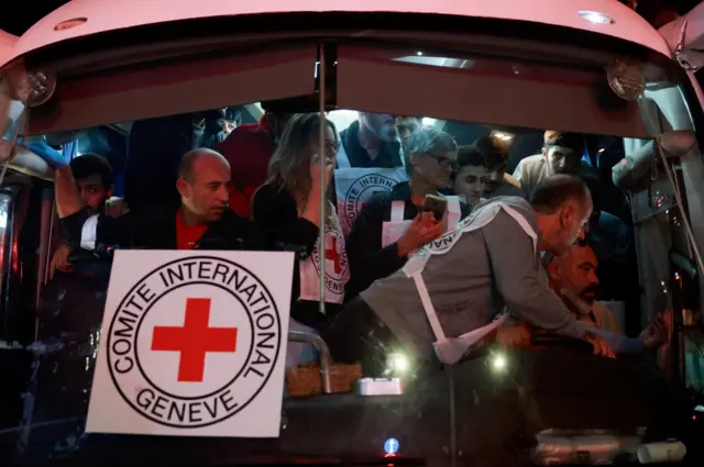 People react inside a vehicle after released Palestinian prisoners left the Israeli military prison