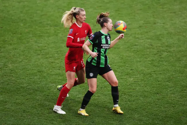 Jenna Clark of Liverpool challenges for the ball with Elisabeth Terland of Brighton.