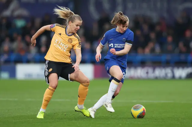 Lena Petermann of Leicester City challenges for the ball with Niamh Charles