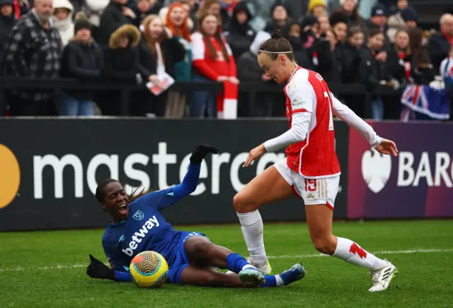 Arsenal's Caitlin Foord in action with West Ham United's Viviane Asseyi