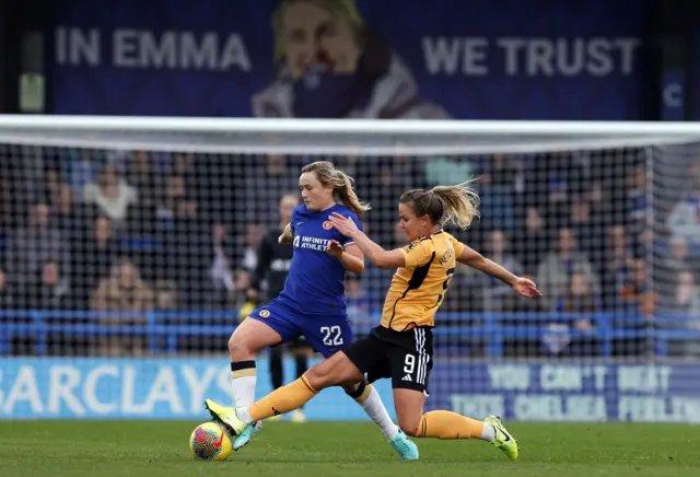 Erin Cuthbert survives a challenge from a Leicester player.