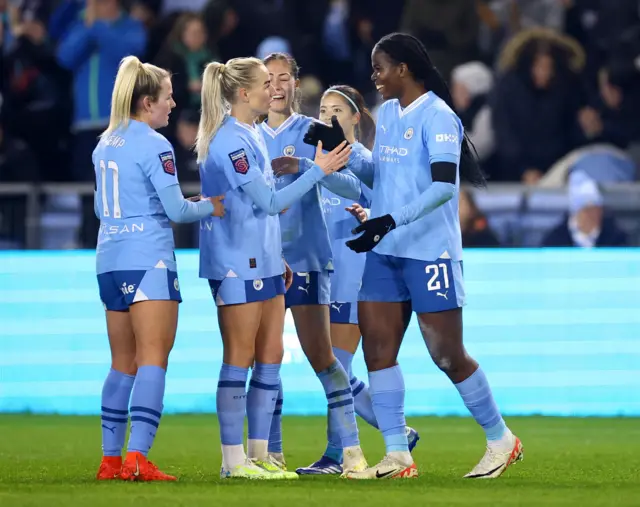 Bunny Shaw and Alex Greenwood high fives with their team mates.