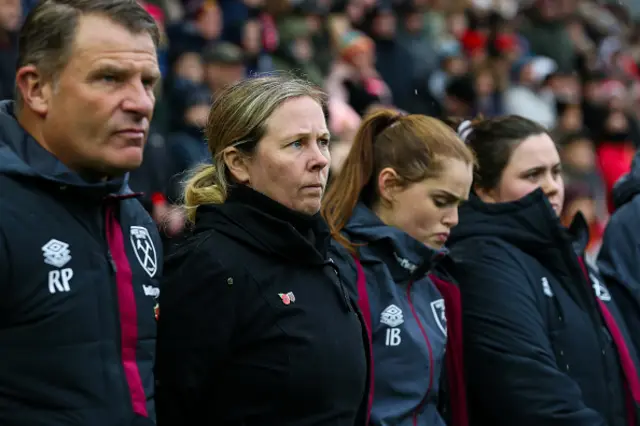 West Ham United manager Rehanne Skinner and her staff observe the Remembrance Sunday