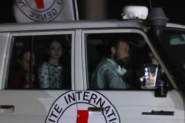 A Red Cross vehicle, as part of a convoy believed to be carrying hostages abducted by Hamas militants during the October 7 attack on Israel