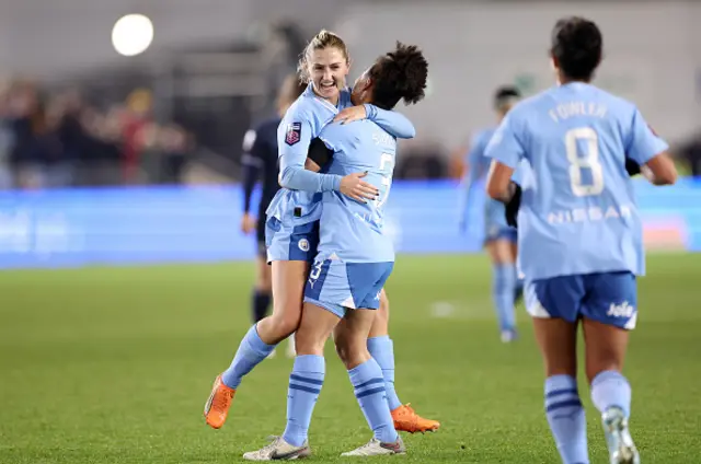 Laura Coombs of Manchester City celebrates with Demi Stokes