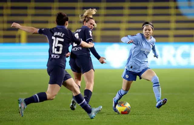 Angharad James and Grace Clinton of Tottenham Hotspur compete for the ball with Yui Hasegawa