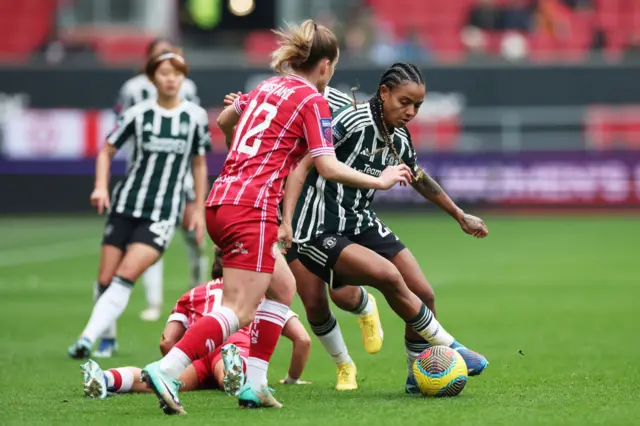 Geyse of Manchester United runs with the ball under pressure.