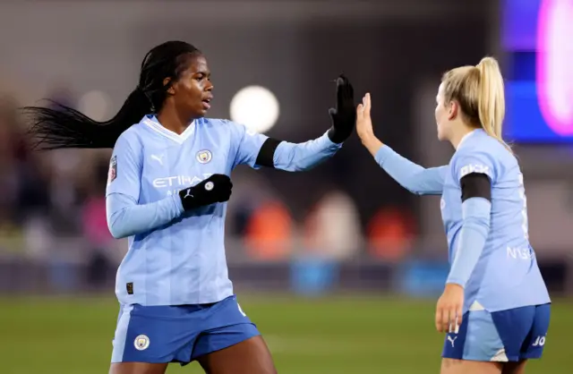 Bunny Shaw high fives Lauren Hemp.