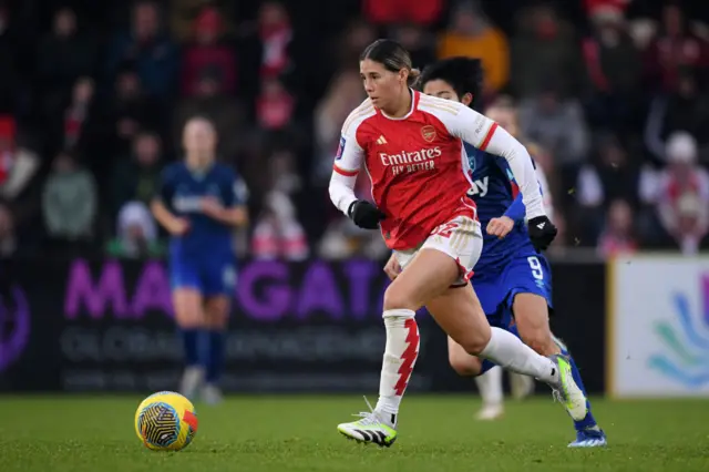 Kyra Cooney-Cross of Arsenal runs with the ball