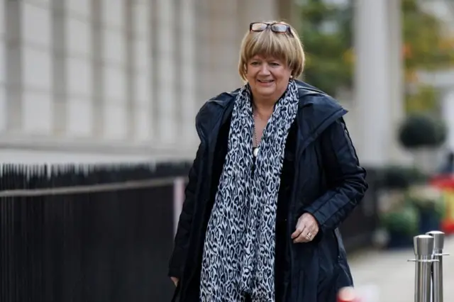 Baroness Hallett walking and smiling