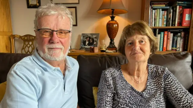 Roger and Pauline in their living room