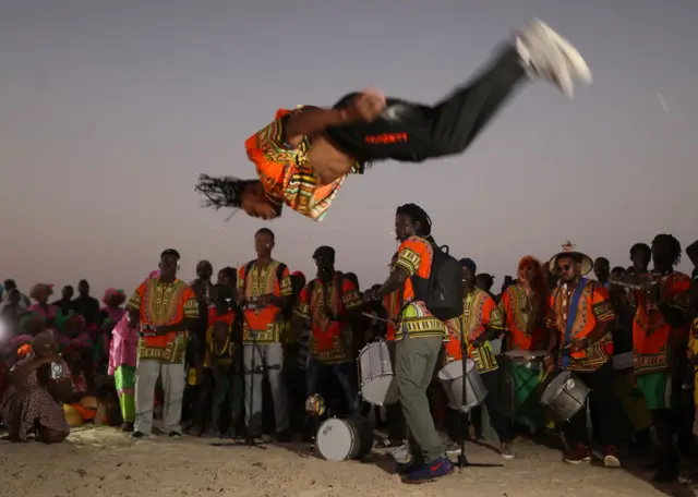 Senegalese people wearing traditional face paints and clothes, perform dances belonging to ethnic group ''Lebu'' settled in Yoff village, during the 4th Dakar Carnival where they celebrate their cultural richness and expressing the diversity of traditional and modern cultural heritage at Kossoupe Beach in Dakar, Senegal on November 26, 202