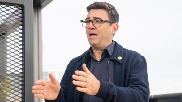 Andy Burnham speaking and gesturing with his hands