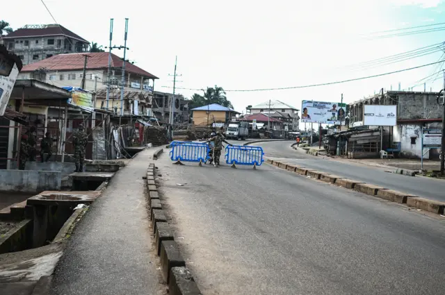 A man is questioned by Sierra leonean military police at a road block in Freetown on November 26, 2023.