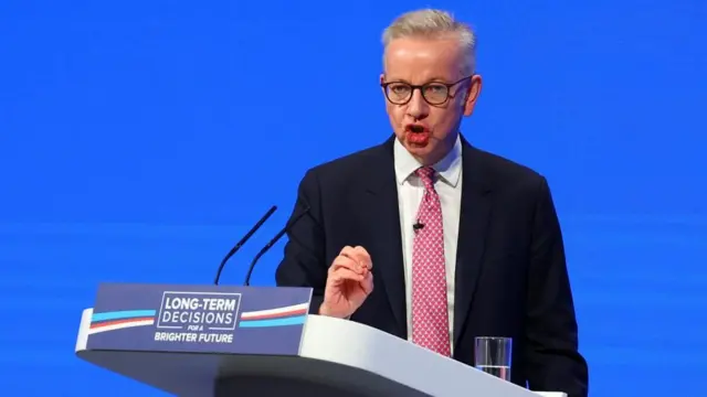 British Secretary of State for Levelling Up, Housing and Communities Michael Gove speaks on stage at Britain's Conservative Party's annual conference in Manchester, Britain, October 3, 2023