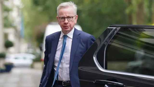 Michael Gove gets out of a car next to Dorland House