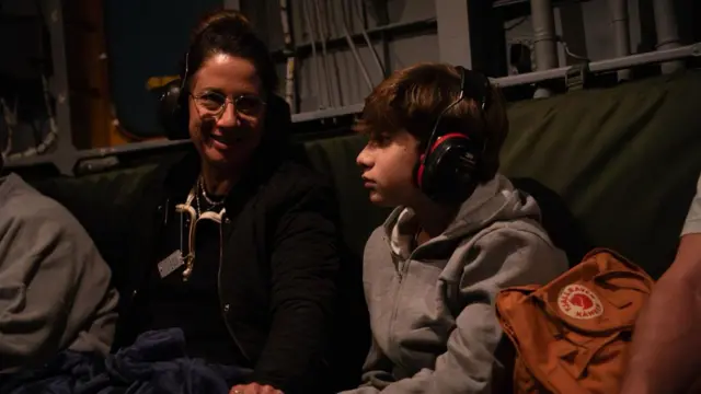 Yagil Yaakov sitting next to a smiling woman