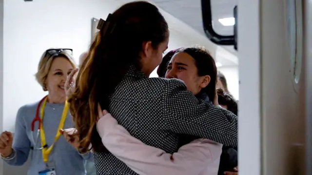 Sarah Kalderon hugging a woman