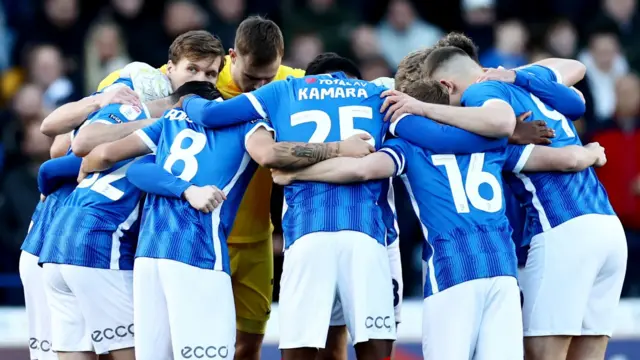 Portsmouth players in a huddle before Blackpool game