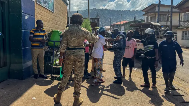 Escaped prisoners are brought back to the Pademba Road Male Correction Centre after being caught by police in Freetown, Sierra Leone, 27 November 2023.