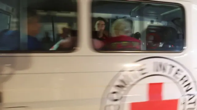 A Red Cross vehicle carrying hostages abducted by Hamas militants during the October 7 attack on Israel arrives at Rafah border, amid a hostages-prisoners swap deal between Hamas and Israel