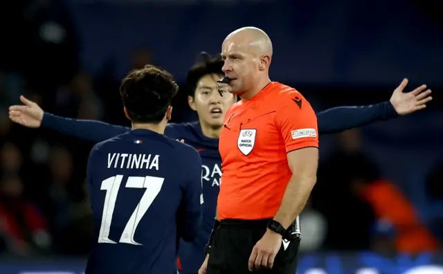 PSG players surround the referee