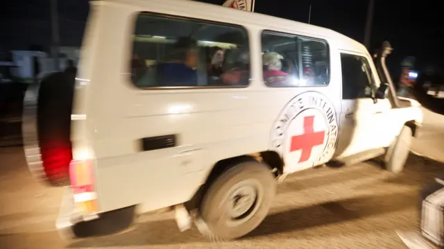 A Red Cross vehicle carrying hostages abducted by Hamas militants during the October 7 attack on Israel arrives at Rafah border, amid a hostages-prisoners swap deal between Hamas and Israel, in southern Gaza Strip, November 28, 2023. REUTERS/Ibraheem Abu Mustafa