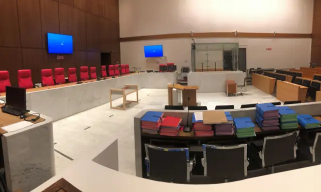 The empty court room showing the box the defendant sits in