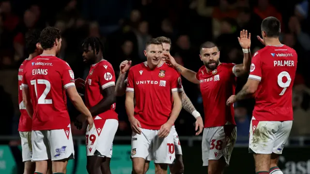 AFC Wrexham players celebrate during their 6-0 win over Morecambe