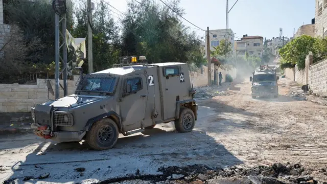 An Israeli military vehicle manoeuvers on a road during a raid in Jenin in the Israeli-occupied West Bank