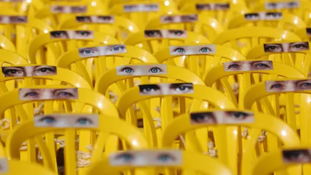 Photographs of hostages eyes are attached to chairs in the plaza of the Tel Aviv Museum in Tel Aviv