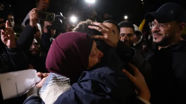 A Palestinian prisoner hugs a relative upon returning from the Ofer Israeli military prison to Ramallah, West Bank