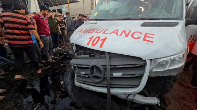 Palestinians check the damage on an ambulance outside Al-Shifa hospital in Gaza City