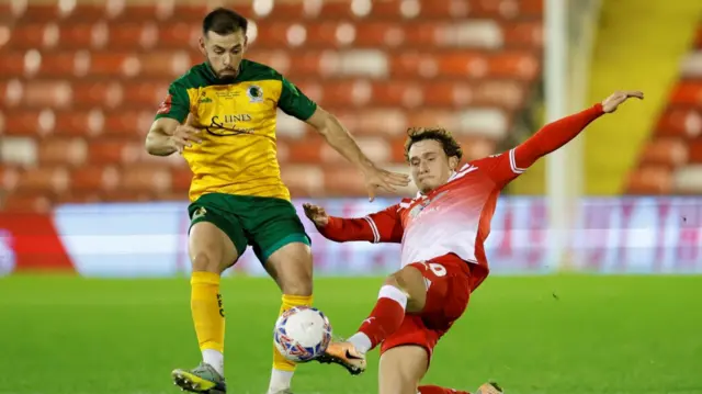 Horsham’s Lucas Rodrigues is tackled by Barnsley’s Callum Styles