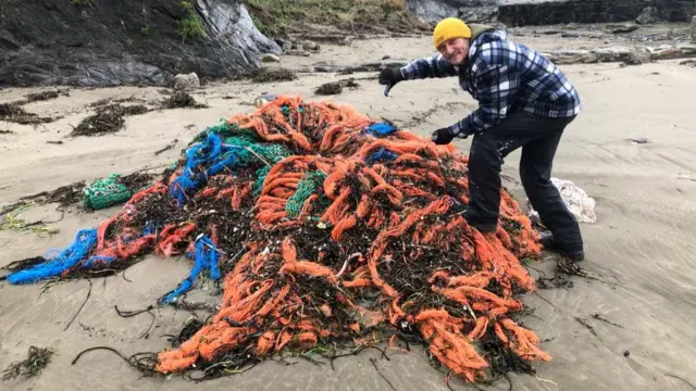 Andy Frost with tangled netting gear on Cornwall beach