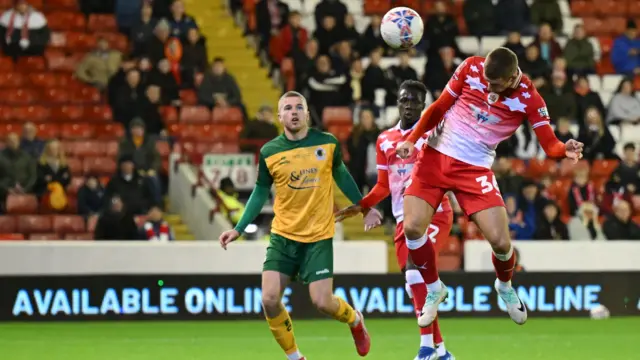 Max Watters heads the ball to score for Barnsley