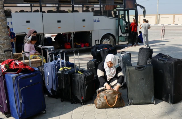 Palestinians with foreign passports go to the Rafah crossing with their belongings by buses, waiting for the gate to open to leave Gaza to Egypt - 3 November 2023