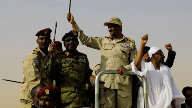 Lieutenant General Mohamed Hamdan Dagalo, deputy head of the military council and head of paramilitary Rapid Support Forces (RSF), greets his supporters as he arrives at a meeting in Aprag village, 60 kilometers away from Khartoum, Sudan, June 22, 201