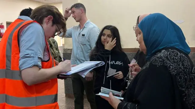 Dual national Palestinians and foreigners undergo identification process as they arrive from the Gaza Strip in the Egyptian side of the Rafah border crossing