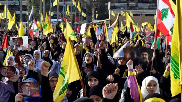 Hezbollah supporters react as they follow the speech of Hezbollah leader Hassan Nasrallah