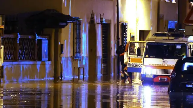 Rescuers work on a flooded street after the storm in Campi Bisenzio, Florence, 03 November 2023.