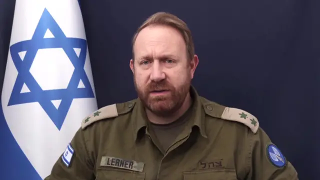 Lerner speaks beside an Israeli flag