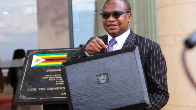 Zimbabwe's Finance Minister Mthuli Ncube stands with a briefcase at the Parliament Building in Mt Hampden on the day he presents the 2024 National Budget, Harare, Zimbabwe November 30, 2023