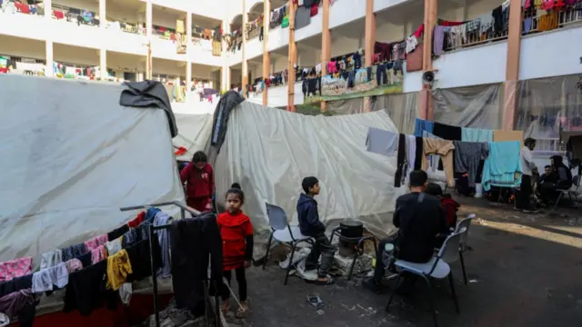 Hung clothes are seen as Palestinians, displaced from their homes try to continue their daily lives at Aliva School in Rafah, Gaza on November 30, 2023.