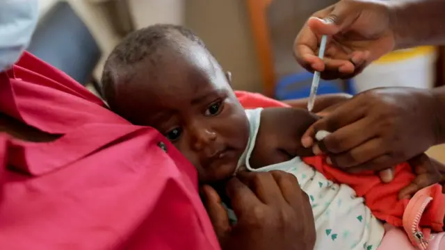 A nurse administers the malaria vaccine to an infant at the Lumumba Sub-County hospital in Kisumu, Kenya, July 1, 2022