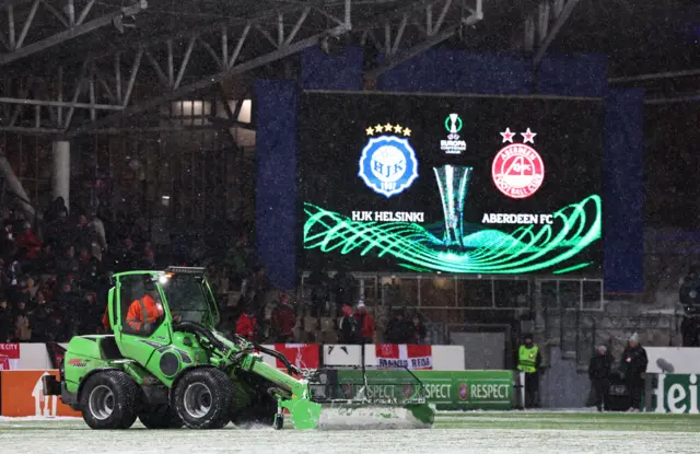 A tractor clears the snow