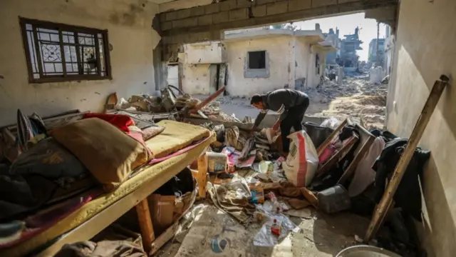 Local looking through the debris of their damaged homes in search of their belongings