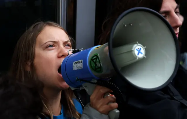 Greta Thunberg speaks into a megaphone