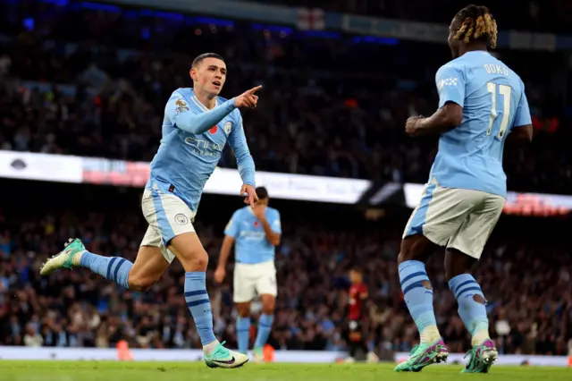 Phil Foden celebrates with Jeremy Doku